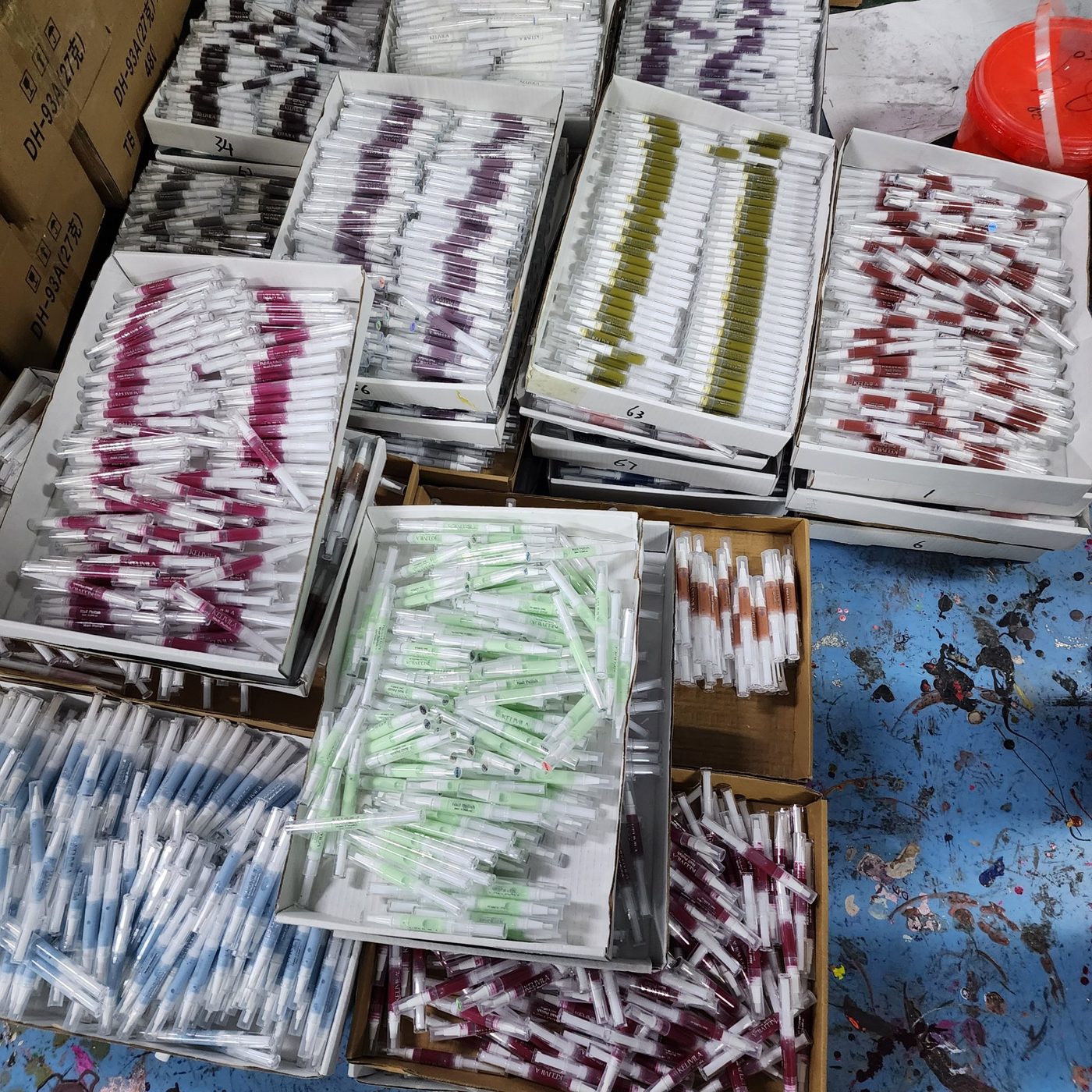 Water-based nail polish pens in production, sorted by shade
